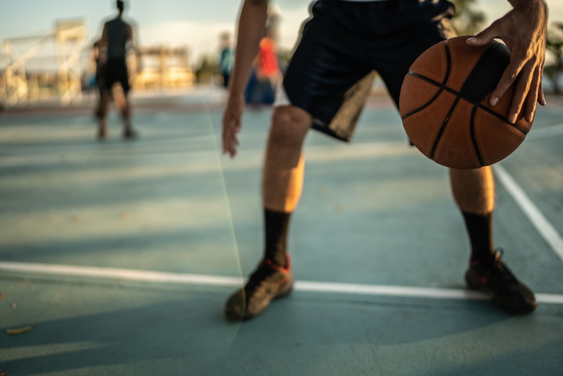 Basketball player dribbling at a basketball court